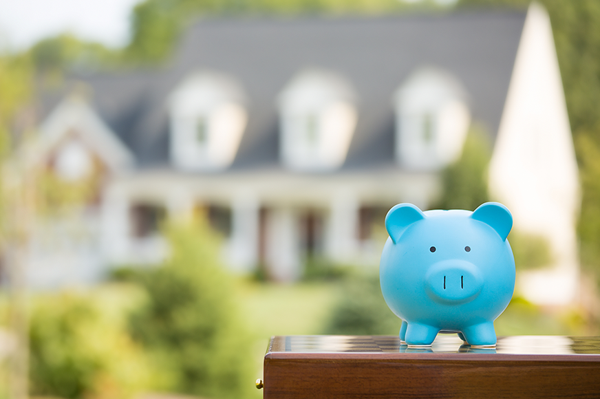 Piggy bank in front of house