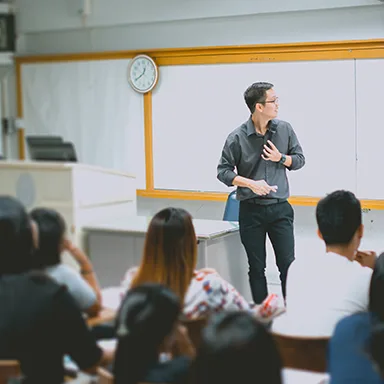 teacher teaching studen in classroom at university