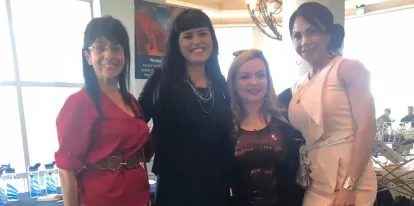 Four women at a community event. 