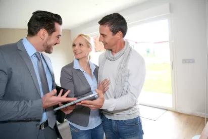 a couple checking out a house with a realtor