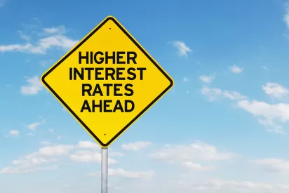 road sign that reads: "higher interest rates ahead"