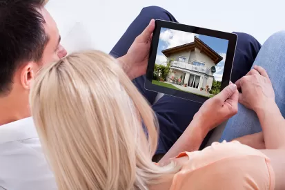 Couple looking at homes on tablet